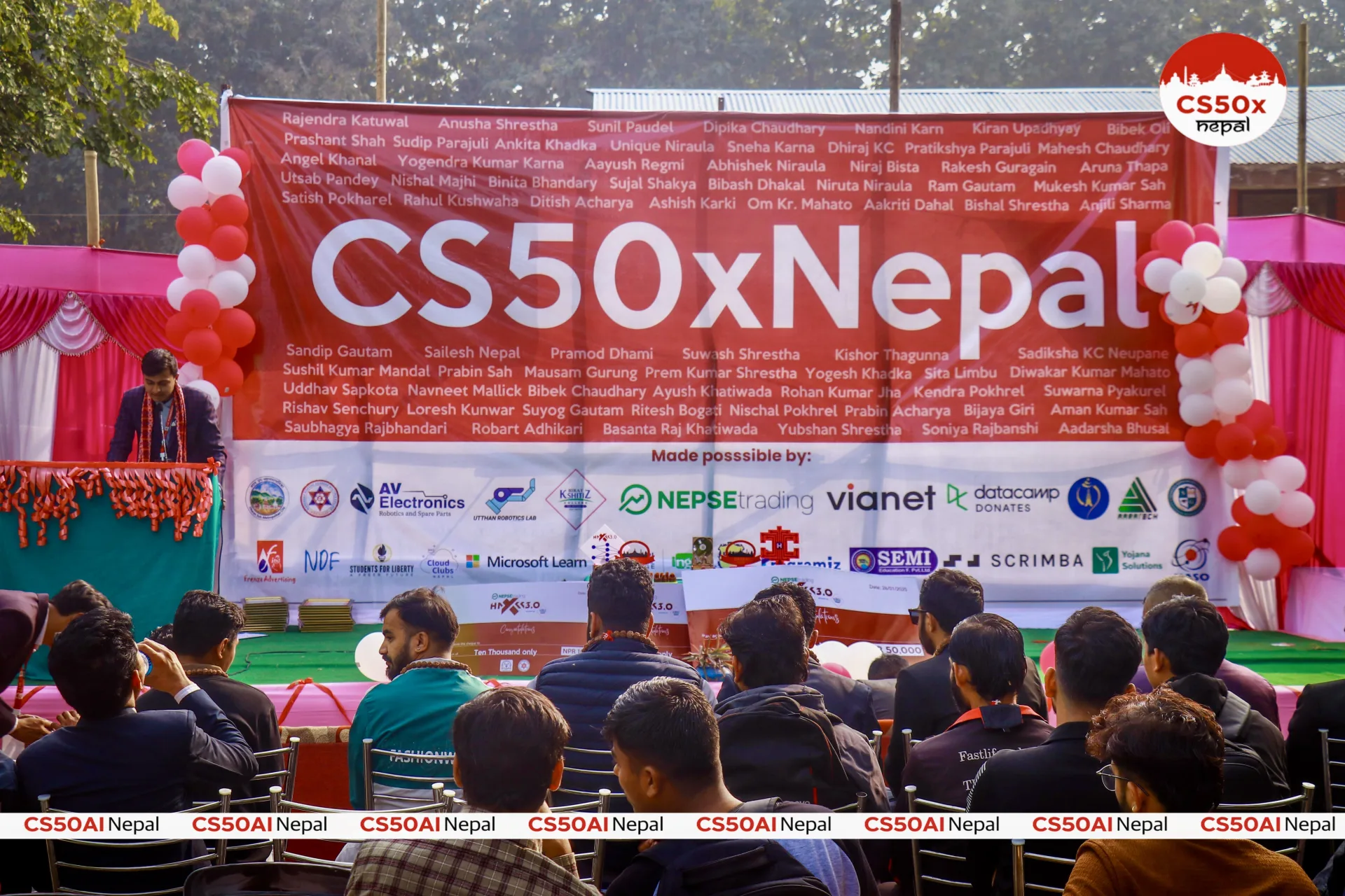 CS50x Nepal stage banner and audience during a public program event.